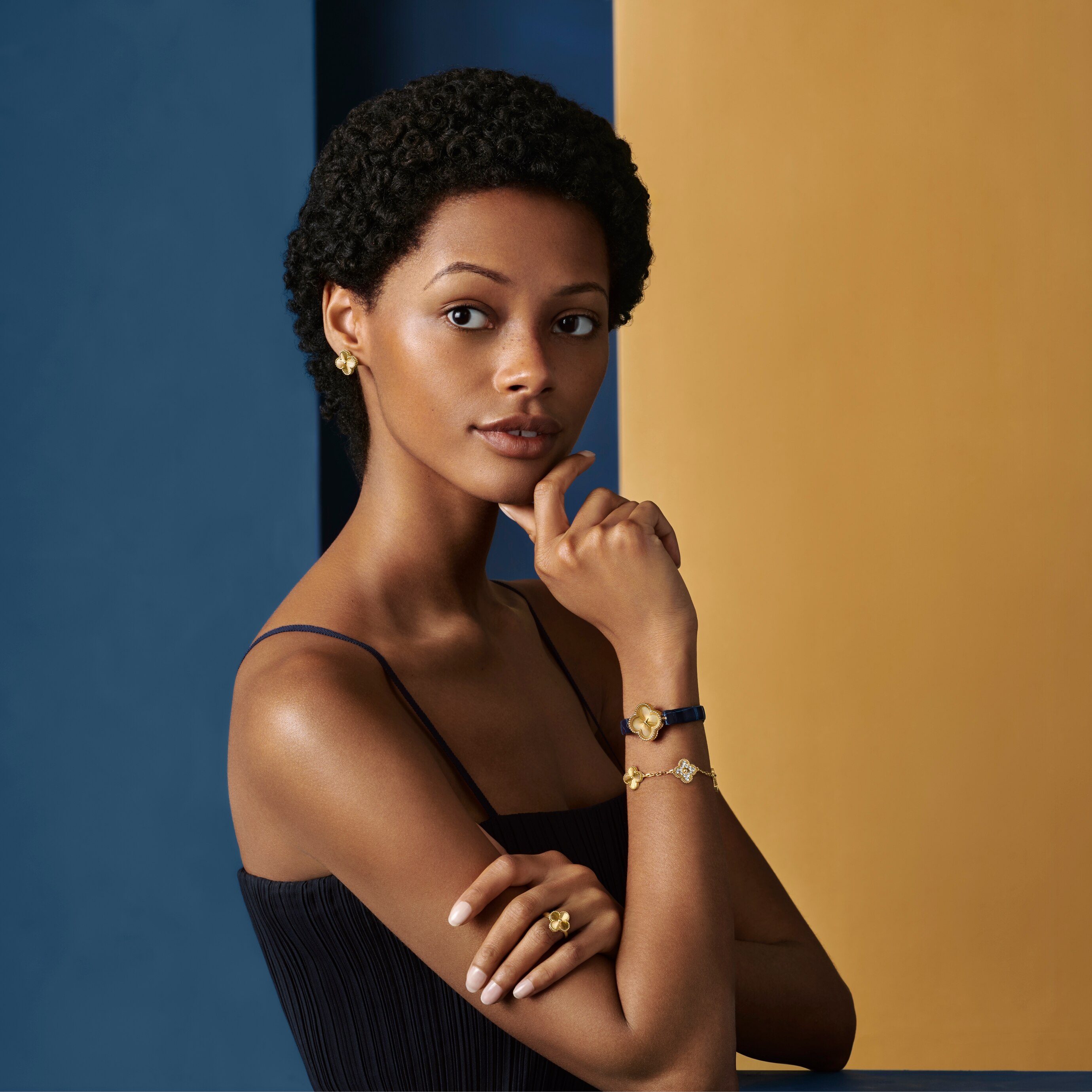 Sweet Alhambra® watch, guilloché 18K yellow gold, quartz movement. Vintage Alhambra® ring, 5 motifs bracelet, and earrings guilloché 18K yellow gold. Alhambra® collection, Van Cleef & Arpels.