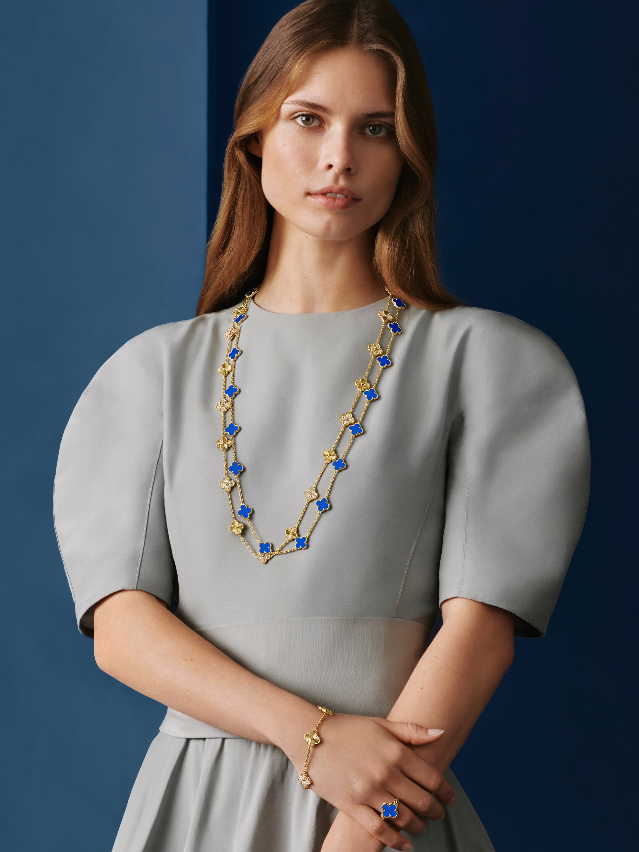 Vintage Alhambra® 20 motifs long necklace and 5 motifs bracelet, guilloché 18K yellow gold, diamonds. 20 motifs long necklace, 18K yellow gold, blue agate and Vintage Alhambra® réversible reversible ring, guilloché 18k yellow gold, blue agate, diamond. Alhambra® collection, Van Cleef & Arpels.